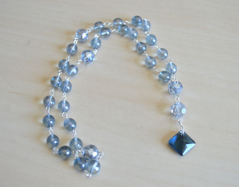 Episcopal prayer beads in light smoky blue with midnight blue Czech crystal focal