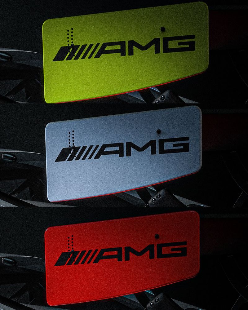 Photos showing the AMG logo on a yellow, a silver and a red rear wing endplate for an AMG GT3