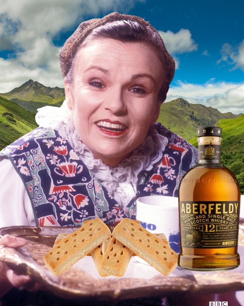 Mrs Overall, wearing a tabard as usual, carries a tea tray with a mug on it, plus a bottle of Aberfeldy whisky and a pile of shortbread. There is a Highland glen in the background and she looks very pleased. 