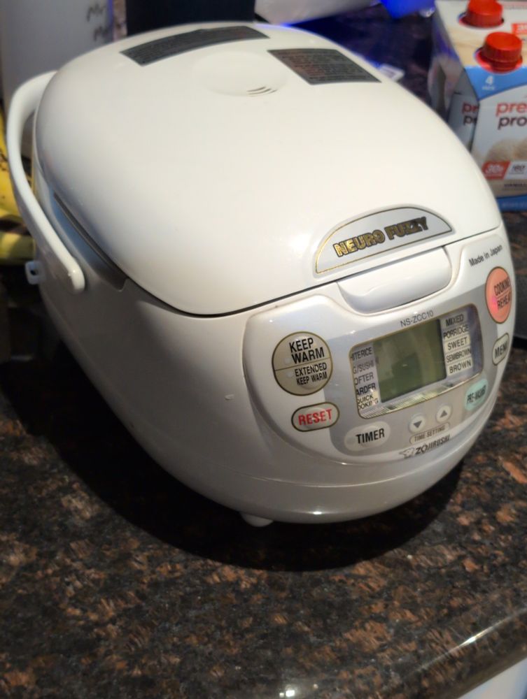  Zojirushi Neuro Fuzzy rice cooker. It's shaped to some degree like a sideways egg.
