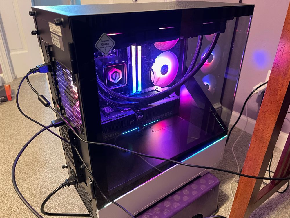 Massive computer tower set up temporarily next to a desk