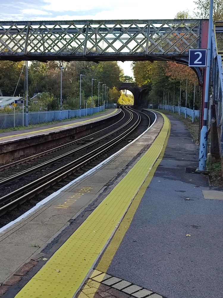 Photo of the train tracks snaking away and under an arched bridge in the direction of Southampton 