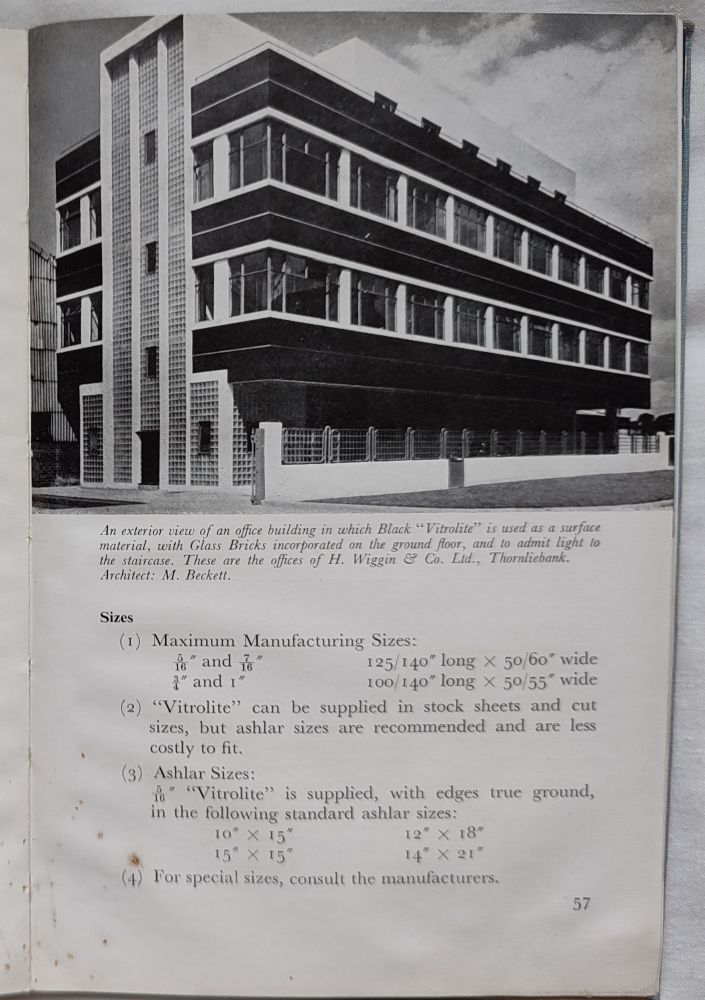 Strong black & white photograph of a modern building. Caption reads:

"An exterior view of an office building in which Black "Vitrolite" is used as a surface material, with Glass Bricks incorporated on the ground floor, and to admit light to the staircase. These are the offices of H. Wiggin & Co. Ltd., Thornliebank. Architect: M. Beckett."