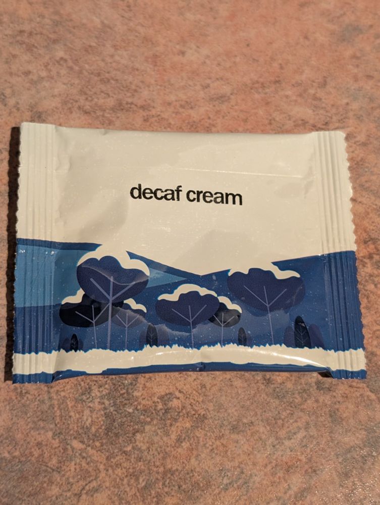 Blue and white tea packet. The image is blue trees topped with white snow.
