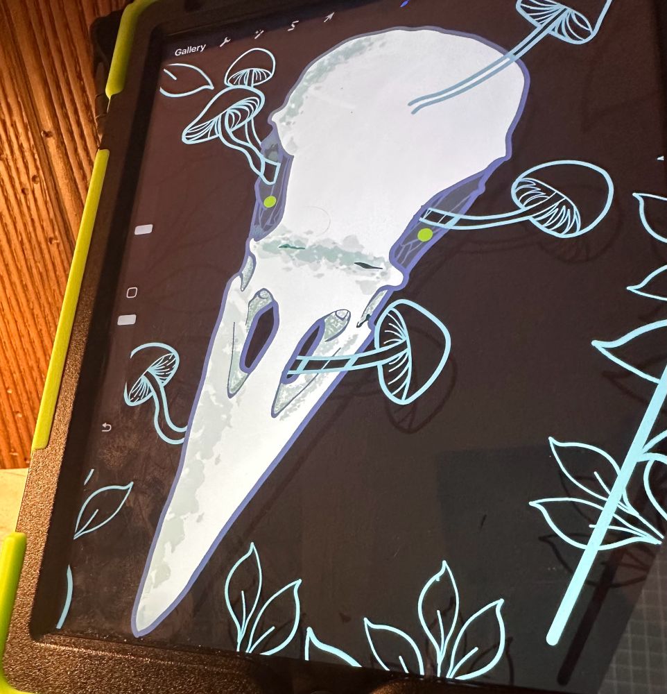Raven skull and mushrooms design on an iPad. 
