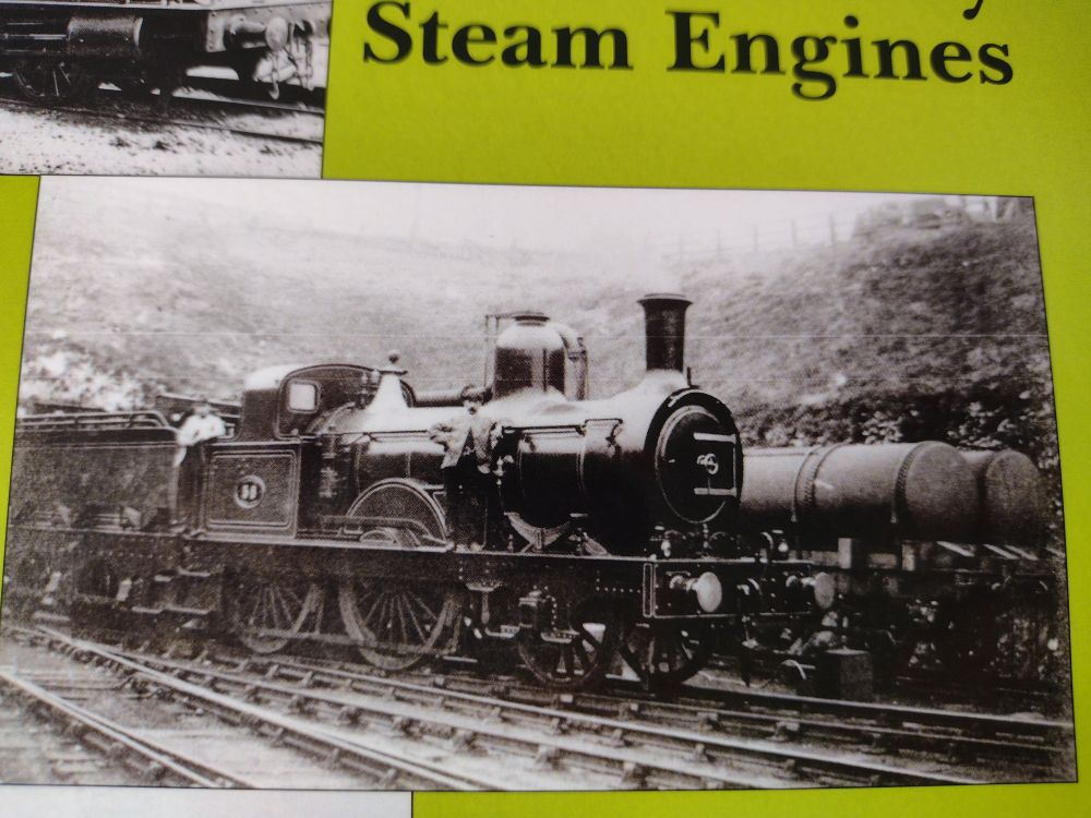A black and white photo of a steam engine, above that some black text saying steam engines, on a green background.