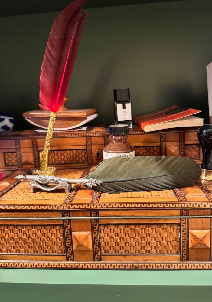 Two of my quill pens on a campaign writing desk.