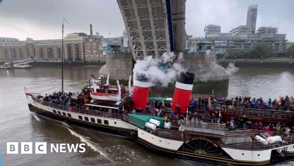 Moment The Waverley paddle steamer passes London's Tower Bridge