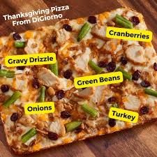Pic of DiGiorno's Detroit style Thanksgiving pan pizza showing toppings of Turkey medallions, green beans, cranberries, crispy onions with a gravy drizzle. Has shredded mozzarella and cheddar cheese.