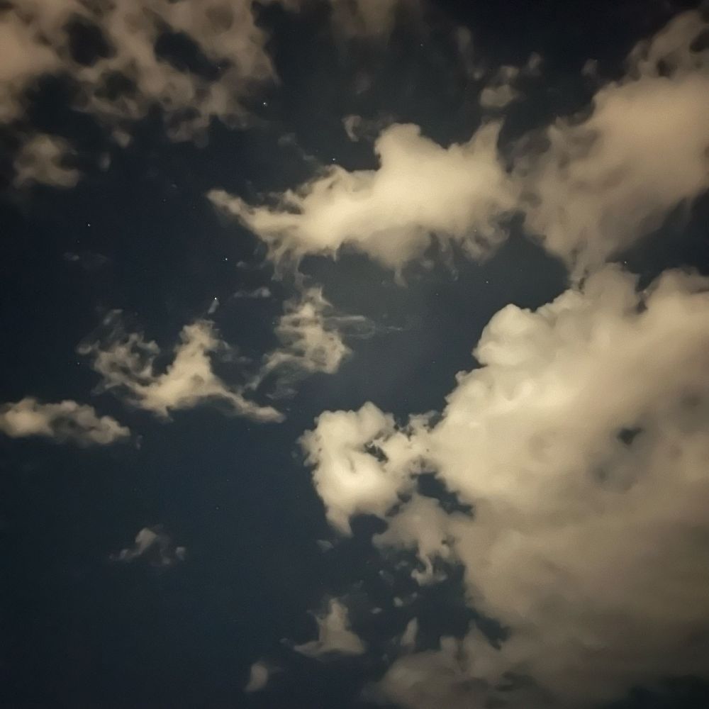 A photograph of a cloudy night sky. It’s surprisingly bright considering there was no moon out. 