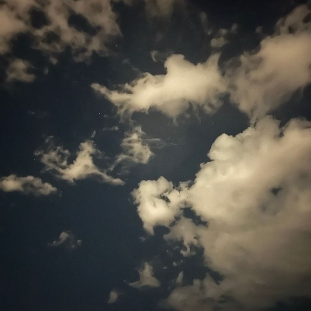 A photograph of some clouds in the night sky. 