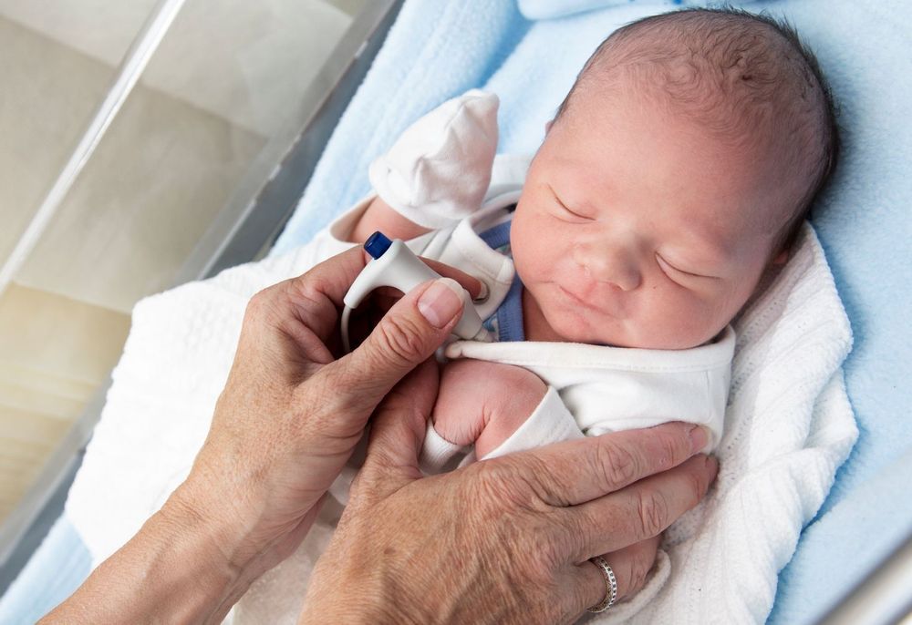 Close up of a newborn baby in an incubator