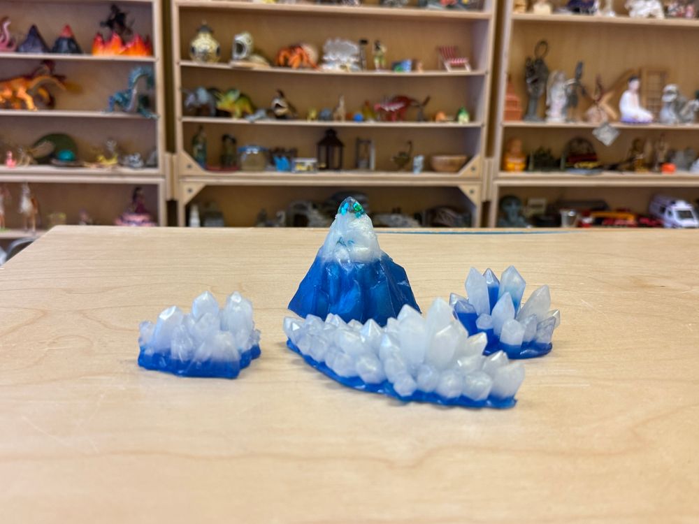 Small blue and white resin mountain and crystals to be used in sand tray therapy. 