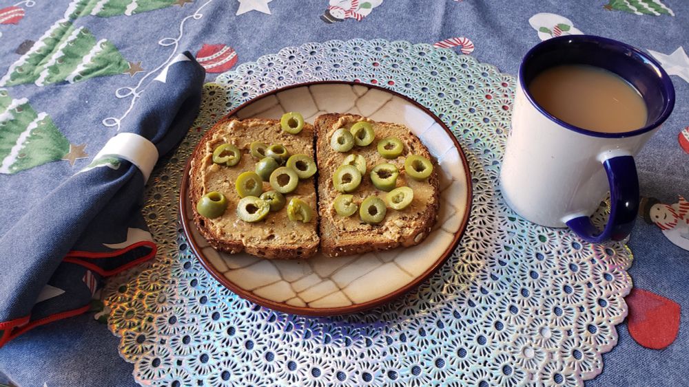 Whole wheat toast with gnarly peanut butter and Castlevetrano olives, Assam tea with milk