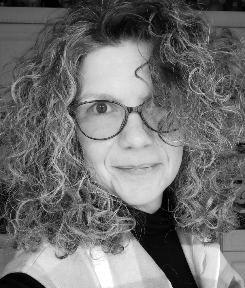Selfie in s/w mit Brille, Lächeln und gewohnten Wuschelhaaren. 