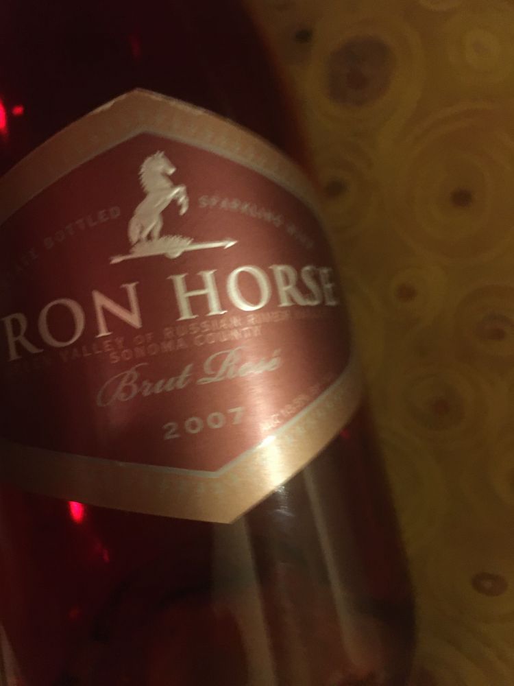 Close up of wine bottle label for 2007 Iron Horse brut rose.

...in front of a tiny section of a fabric print of Klimt's The Kiss.