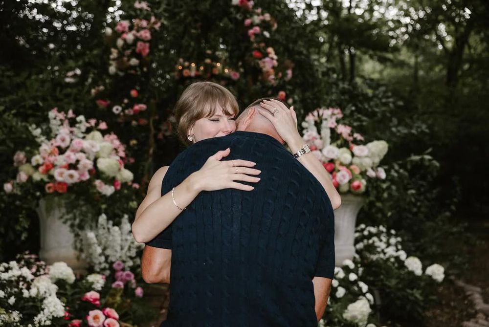 Taylor hugs Travis 