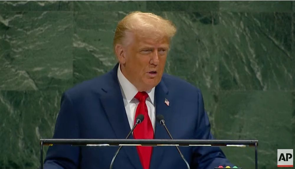 Trump in a blue suit and a red tie