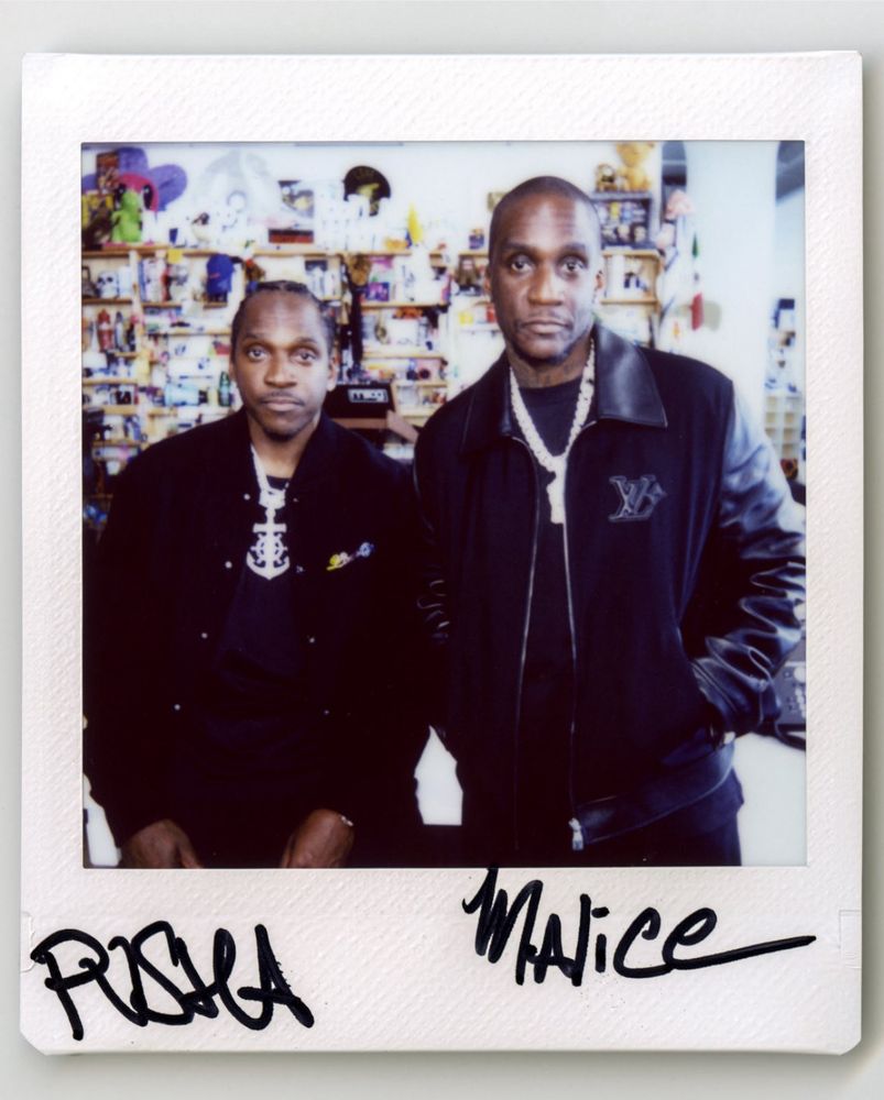 A photo of Pusha T and Malice, wearing black jackets 