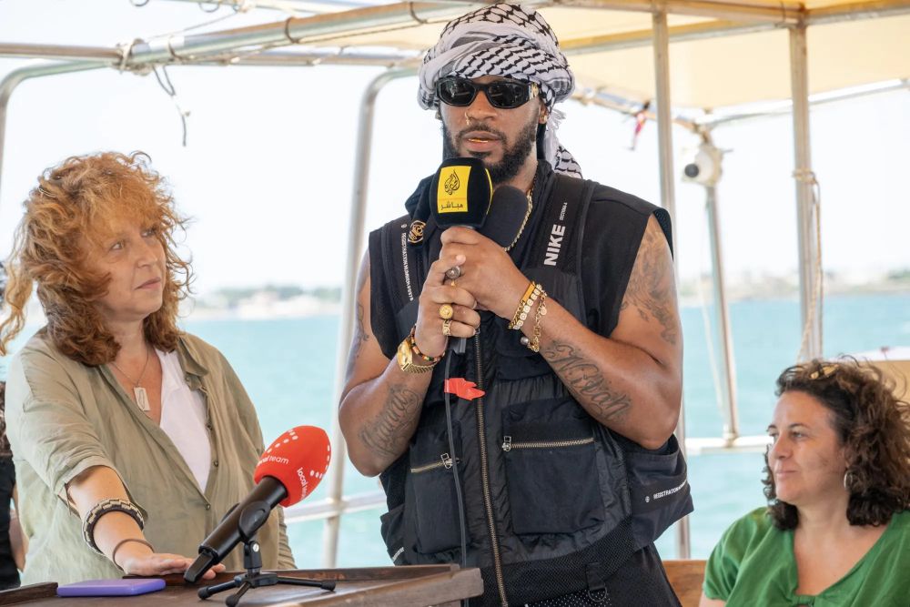 A photo of labor activist Chris Smalls, talking into a mic 