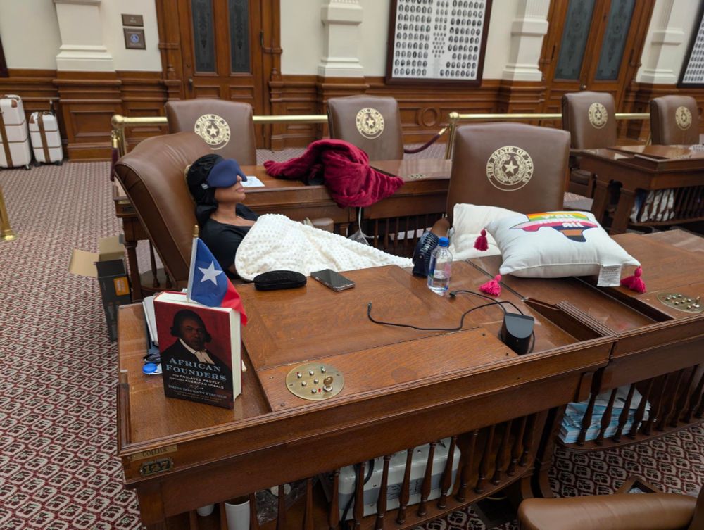 Texas state Rep. Nicole Collier on the House floor, with a blanket, pillows and a book