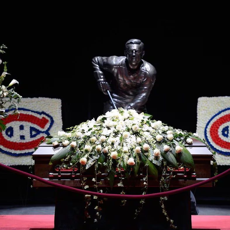 The photo shows Jean Béliveau, wearing a Montreal Canadiens jersey with the number 4 and a captain's 