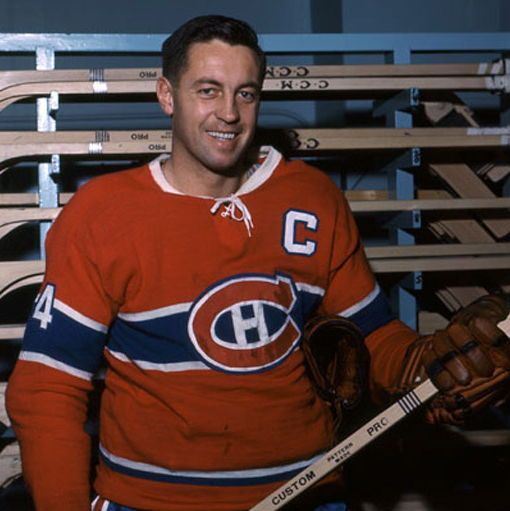 The photo shows Jean Béliveau, a legendary hockey player, wearing a red Montreal Canadiens jersey with the number 4 and a captain's 