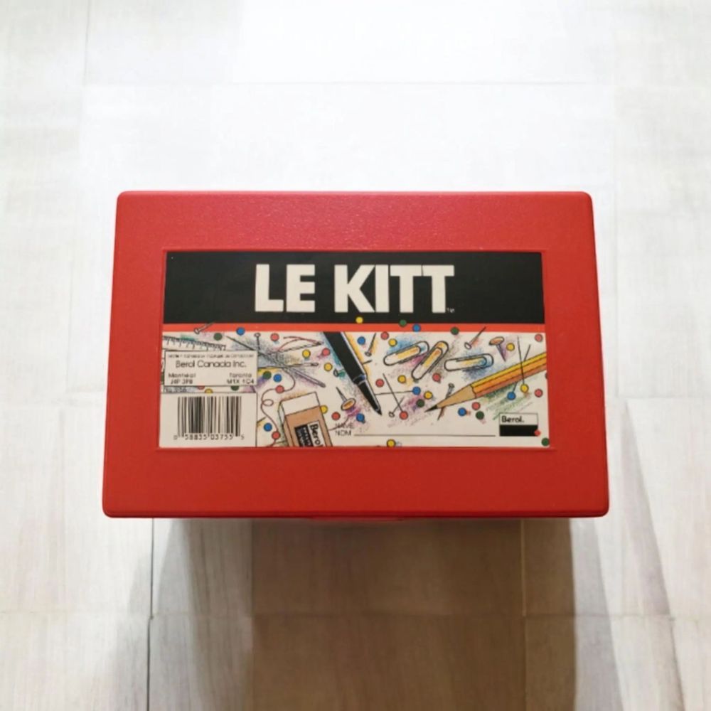 A photograph of a red plastic box labeled 