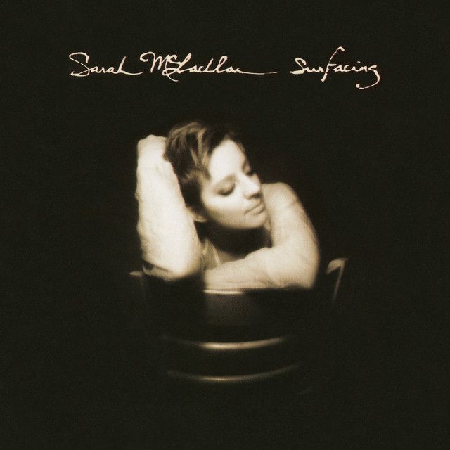 The photo features a sepia-toned image of a person with short hair, sitting in a chair with their arms resting on the backrest and their head gently leaning on their hands. The background is dark, creating a moody and intimate atmosphere. At the top, the text 