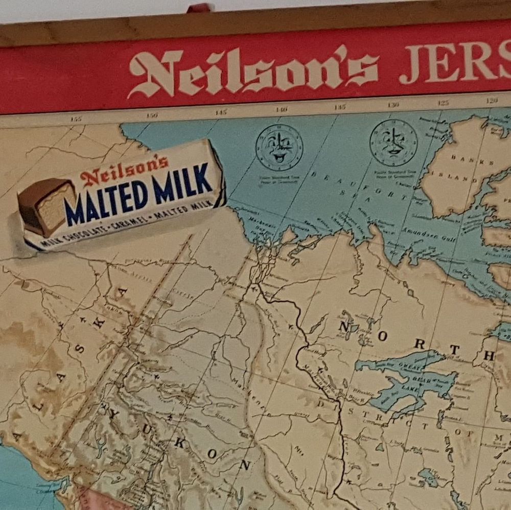 A section of a vintage map featuring the northern regions of Canada, including areas labeled as Yukon, Northwest Territories, and Mackenzie District. The map is framed with a red border displaying the text 
