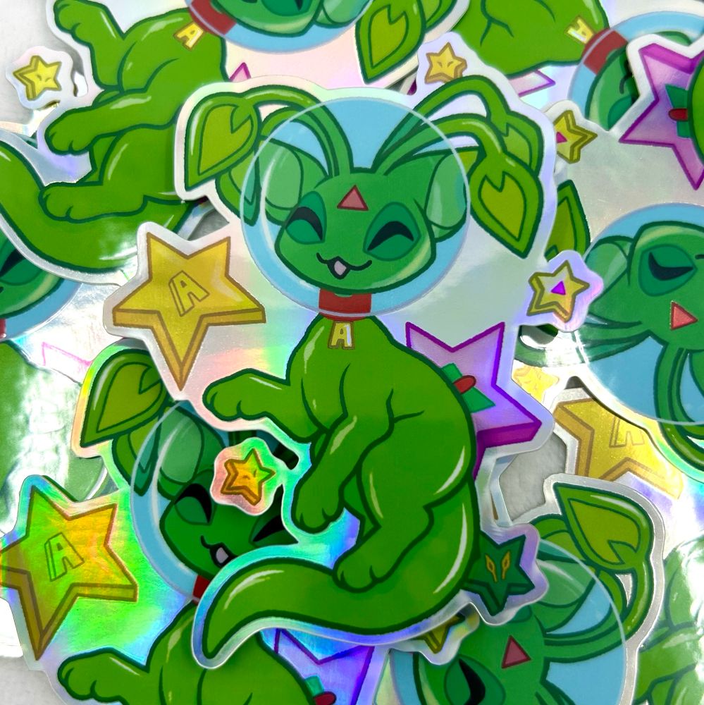 A sticker of a green alien Aisha surrounded by stars