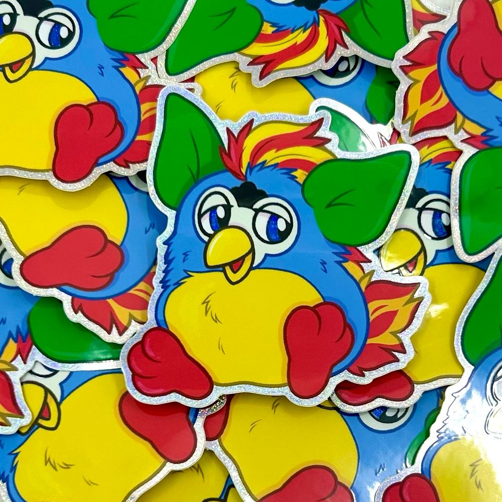 A sticker of the kid cuisine furby that is red yellow blue and green