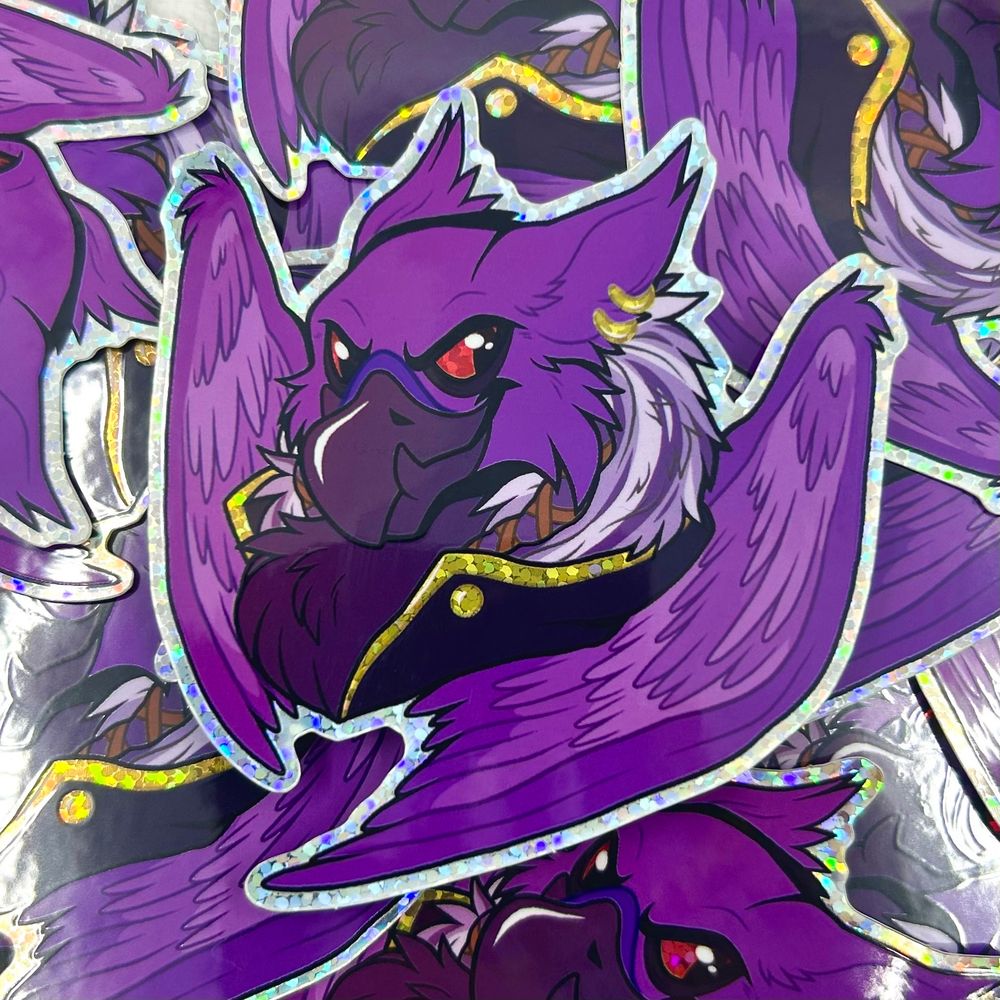 A pile of stickers, the top being a purple eyrie with red eyes