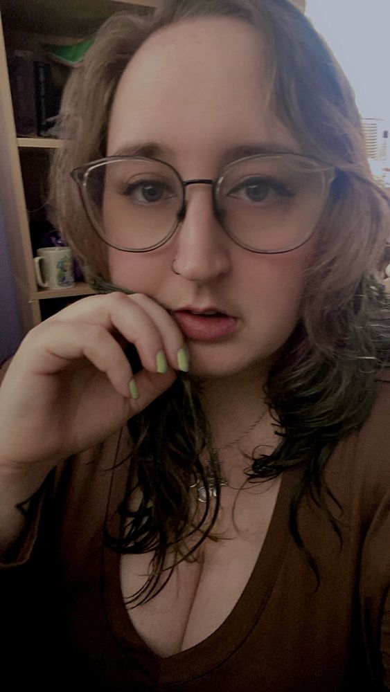 selfie of me w a brown shirt, large glasses, brown eye makeup