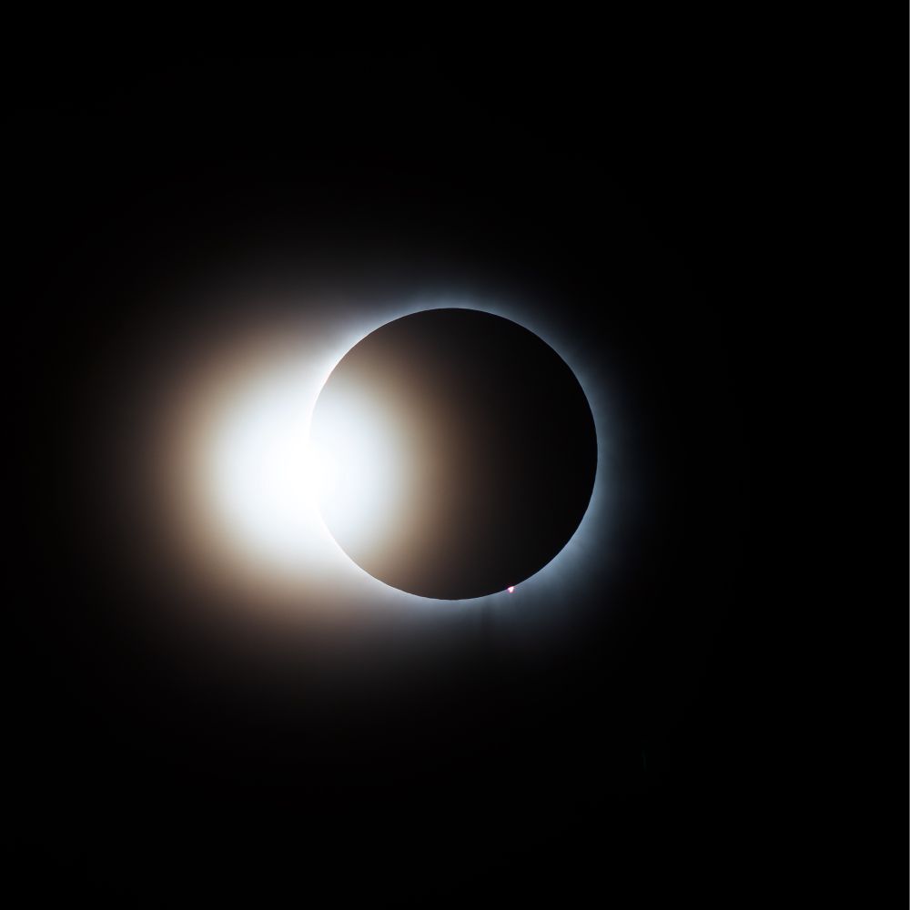 Sun blowing up left side of moon with ring visible