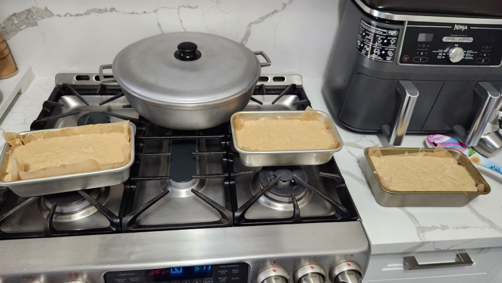 three bread loaf pans full of banana bread batter