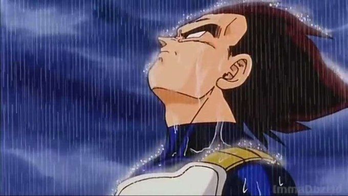 Vegeta standing in the rain with his head looking upwards.