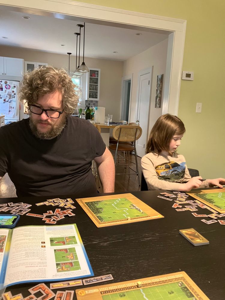 A dad and his daughter play My City