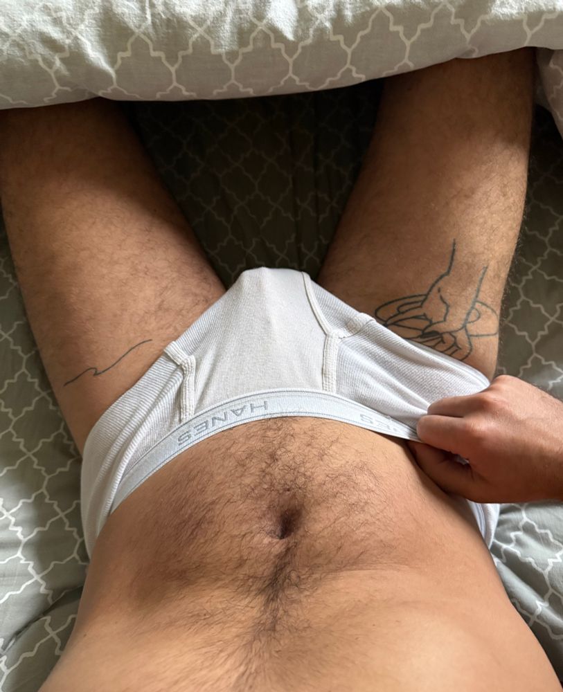 Photo in bed in white Hanes tighty whities underwear with visible cage print 