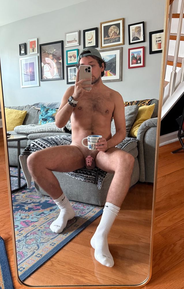 Selfie in mirror naked with socks and cage on and coffee in my hand bc I neeeeed it