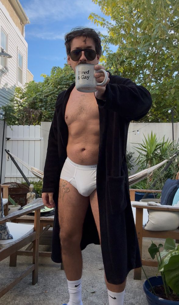 Photo of self standing outside in sunny yard in robe white briefs and socks 