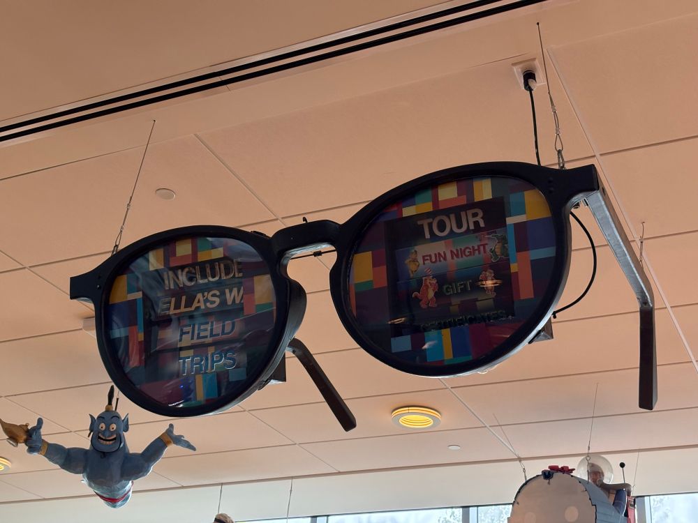 An animated sign encouraging field trips to Ella’s Deli, in the shape of rather psychedelic eye glasses.