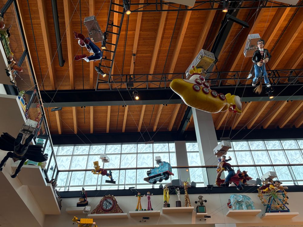 Various animated figures from pop culture fly around on elevated tracks.