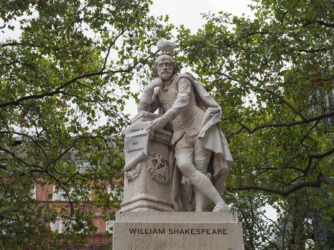 A statue of Shakespeare, with a gull balanced on his head. 