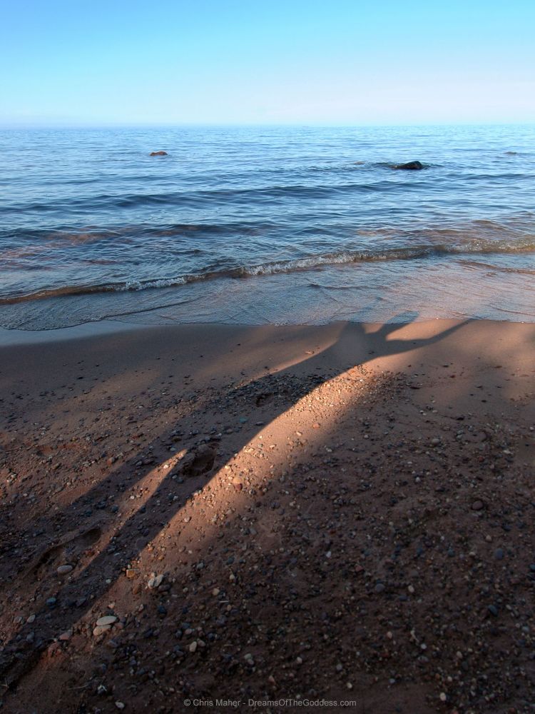 A woman’s shadow on the beach