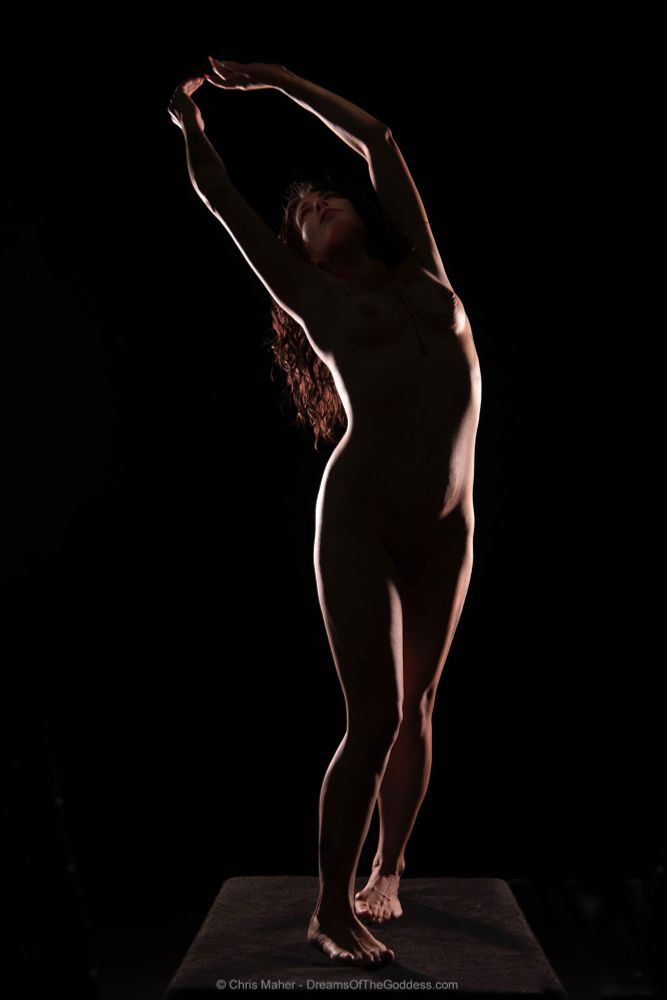 She stood on a platform the light outlining her naked curves.