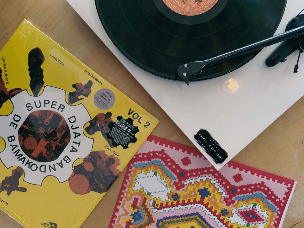 A photo of Super Djata Band on a white turntable. Shot from above, great colours on the inner sleeve.