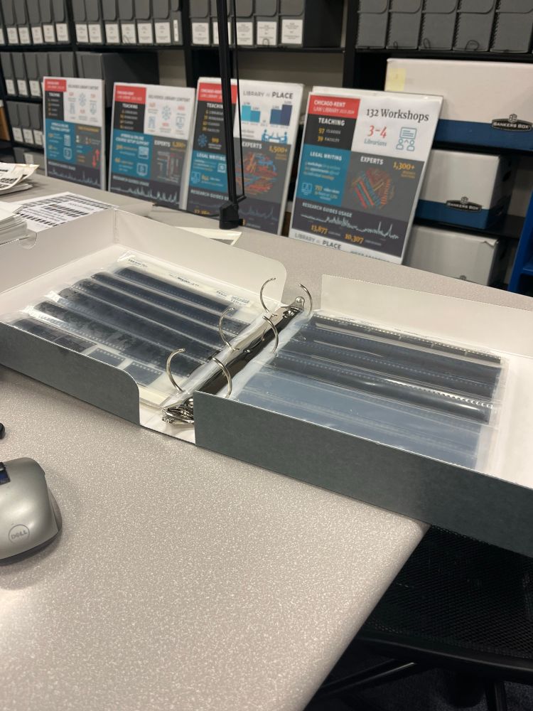Gray binder holding film strips. 