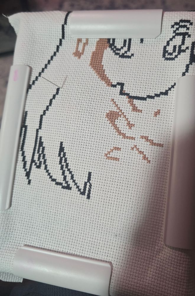 an in-progress cross stitch featuring an anime character
