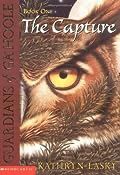 An image of the first Guardians of Ga’Hoole book, The Capture. The book cover features one half of a great horned owl’s face.